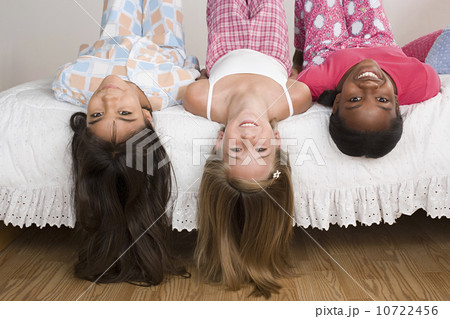 Three girls (10-11) having fun at slumber party 10722456