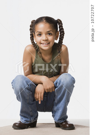 Studio portrait of smiling girl (8-9) with plaits Studio portrait of smiling girl (8-9) with plaits 10722707