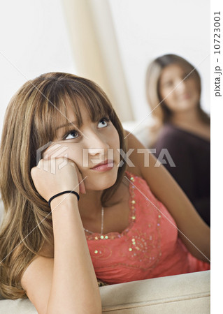 Angry daughter sitting with mother on sofa Angry daughter sitting with mother on sofa 10723001