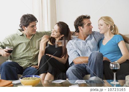 Portrait of two smiling couples sitting on sofa Portrait of two smiling couples sitting on sofa 10723165