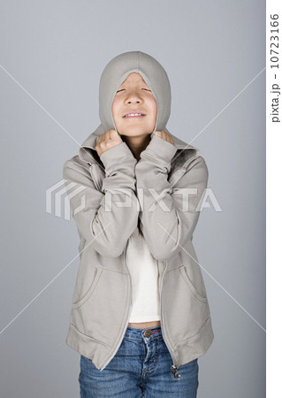 Studio shot portrait of teenage girl in hooded shirt, waist up Studio shot portrait of teenage girl in hooded shirt, waist up 10723166
