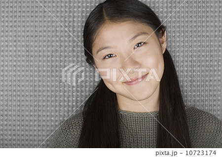 Studio portrait of young woman smiling Studio portrait of young woman smiling 10723174