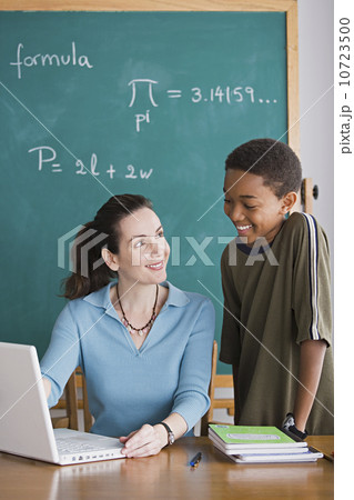 Teacher with schoolboy in classroom Teacher with schoolboy in classroom 10723500