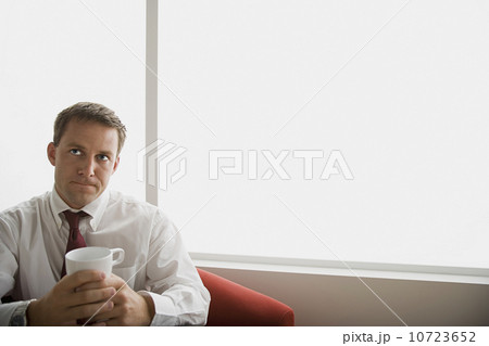 Portrait of businessman sitting with mug Portrait of businessman sitting with mug 10723652