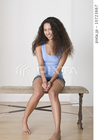 Young woman sitting on bench 10723667