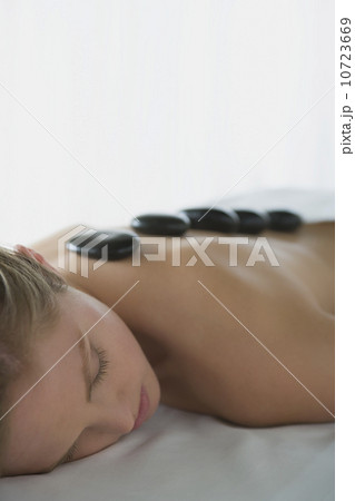 Woman enjoying hot stone therapy Woman enjoying hot stone therapy 10723669