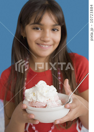 Portrait of smiling girl (10-11) holding dessert Portrait of smiling girl (10-11) holding dessert 10723884