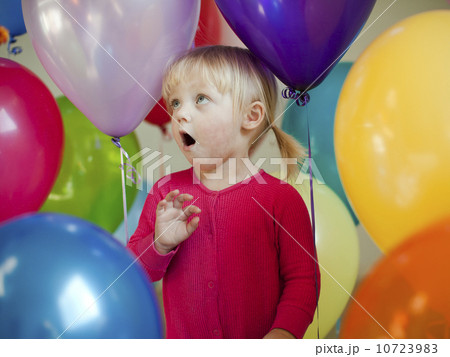 Portrait of baby girl (18-23 months) wit colorful balloons Portrait of baby girl (18-23 months) wit colorful balloons 10723983