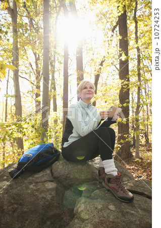Female hiker using digital tablet in forest Female hiker using digital tablet in forest 10724253