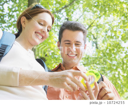 Couple hiking with compass in forest Couple hiking with compass in forest 10724255