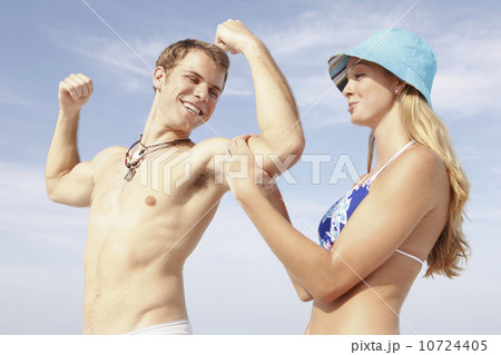 Young man flexing muscles for girlfriend Young man flexing muscles for girlfriend 10724405
