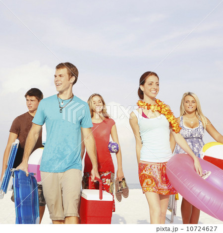 Friends walking with beach essentials Friends walking with beach essentials 10724627