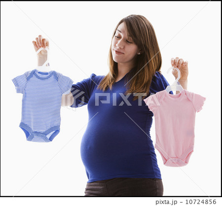 Studio Shot of pregnant woman holing baby onesie 10724856