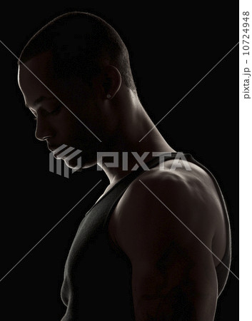 Studio shot of muscular young man wearing tank top 10724948
