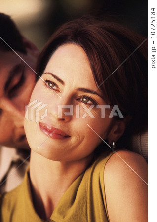 Smiling woman with affectionate man behind her Smiling woman with affectionate man behind her 10725184