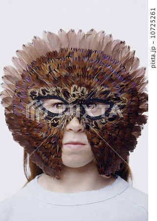Child wearing a feather mask Child wearing a feather mask 10725261
