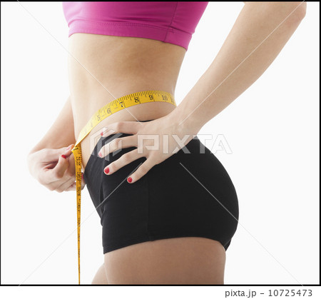Young woman measuring waist 10725473