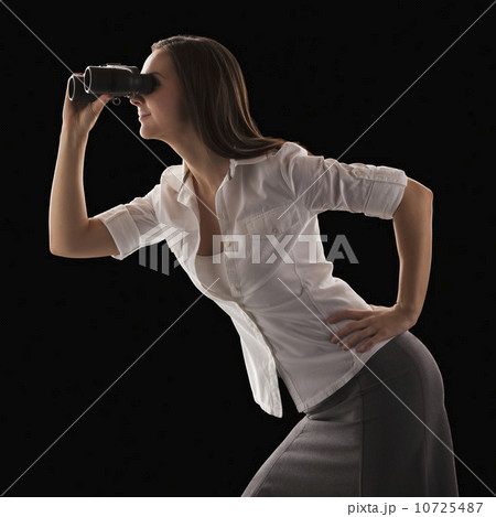 Young attractive businesswoman looking through binoculars Young attractive businesswoman looking through binoculars 10725487