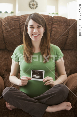 Portrait of pregnant woman showing ultrasonography scan Portrait of pregnant woman showing ultrasonography scan 10725570