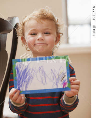 Boy (4-5) showing his drawing 10725581