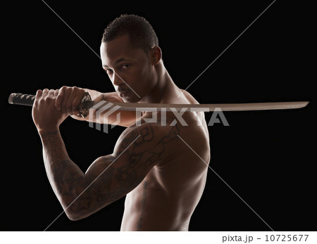 Studio shot of martial arts practitioner with Katana sword Studio shot of martial arts practitioner with Katana sword 10725677