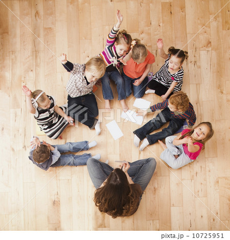 Children (2-3, 4-5) sitting on floor and raising hands, directly above 10725951