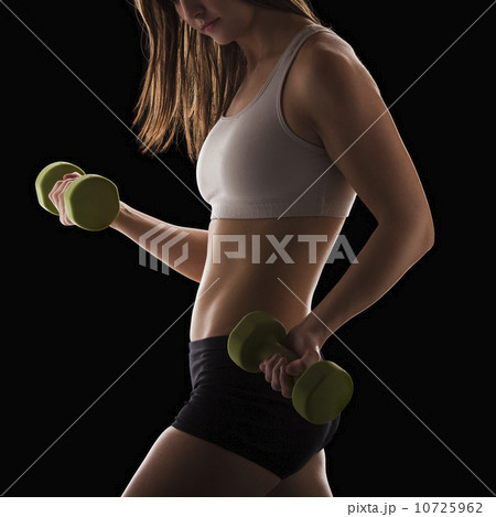 Young woman using hand weights 10725962