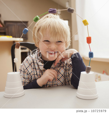 Boy (4-5) with his craft work 10725979