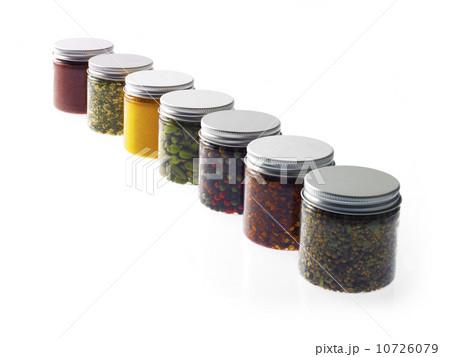 Studio shot of row of jars with spices 10726079