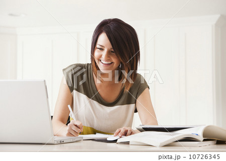 Portrait of young woman learning at home 10726345