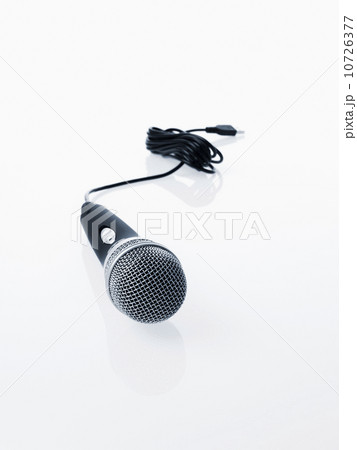 Studio shot of microphone and microphone cable on white background Studio shot of microphone and microphone cable on white background 10726377