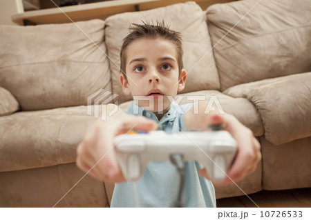Front view of boy (8-9) playing Video Games Front view of boy (8-9) playing Video Games 10726533