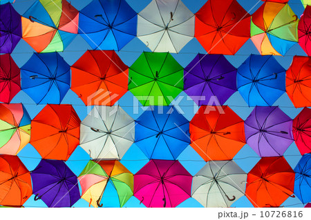 Background picture of a lot of colored umbrellas in front of blue sky 10726816