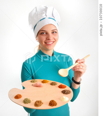 Spices and herbs on the palette and cook girl 10730010