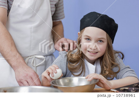 Young girl cracking an egg 10738961