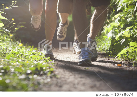 Canada, British Columbia, Fernie, Foot of three jogging people 10739074