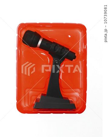 New wireless microphone still in case on red background 10739081