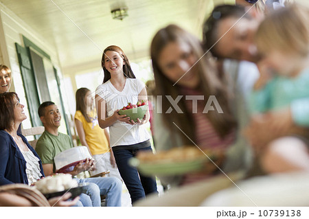 Girls (10-11, 2-3, 14-15)  with father and family during celebration event 10739138
