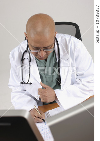 Doctor working at his desk 10739357