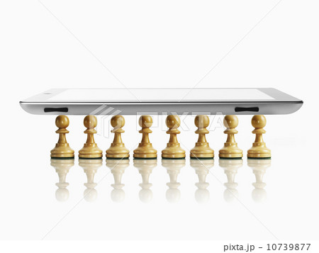 Digital tablet on wooden chess pawns, studio shot 10739877