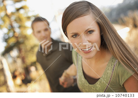 Woman pulling boyfriend by the hand Woman pulling boyfriend by the hand 10740133