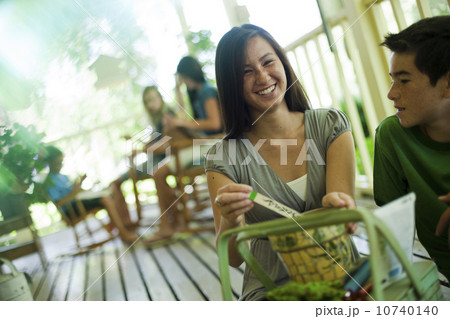 Family relaxing on porch Family relaxing on porch 10740140