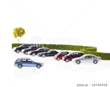 Row of different cars parked near hedge Row of different cars parked near hedge 10740458