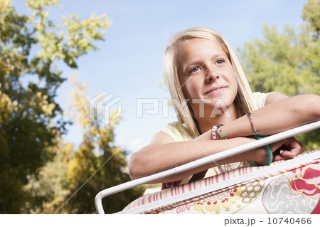 USA, Utah, outdoor of  blonde girl  (12-13)leaning on deck chair 10740466