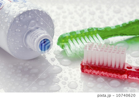 Close-up of toothpaste and toothbrushes covered with water drops Close-up of toothpaste and toothbrushes covered with water drops 10740620