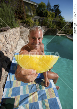 USA, California, Oakland, Senior man relaxing at swimming pool 10740689