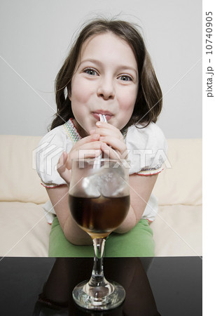 Portrait of happy girl (8-9) drinking 10740905