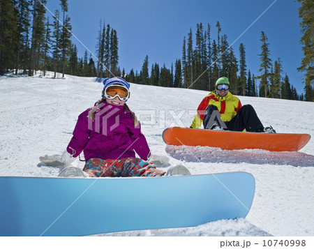 USA, Colorado, Telluride, Father and daughter (10-11) posing with snowboards in winter scenery USA, Colorado, Telluride, Father and daughter (10-11) posing with snowboards in winter scenery 10740998