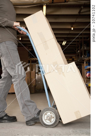 Man pushing a dolly Man pushing a dolly 10741102