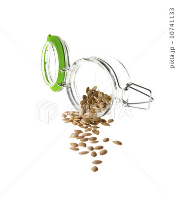 Studio shot of jar with Pumpkin Seeds on white background Studio shot of jar with Pumpkin Seeds on white background 10741133